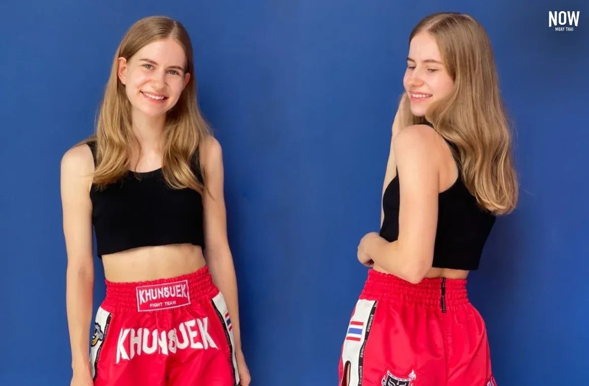 Woman wearing Muay Thai shorts and a sports top during training