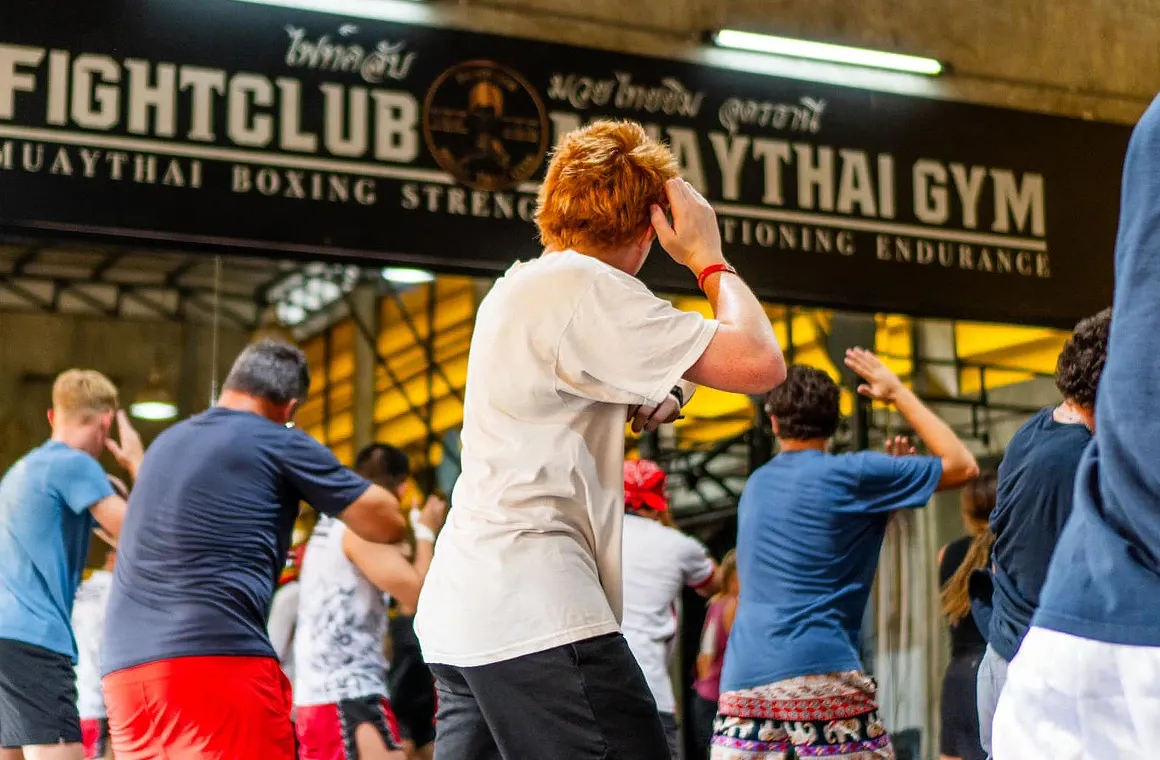 Students participating in a Muay Thai group class for all levels at Fight Club Muay Thai Gym, focusing on improving their skills.