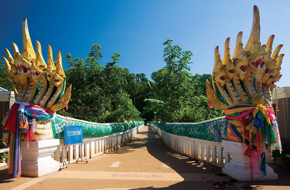 The Naga Bridge with 9 heads at Wat Siri Sutho, Kham Chanot, leading to the sacred forest and underwater palace believed to be the home of the Naga serpent.