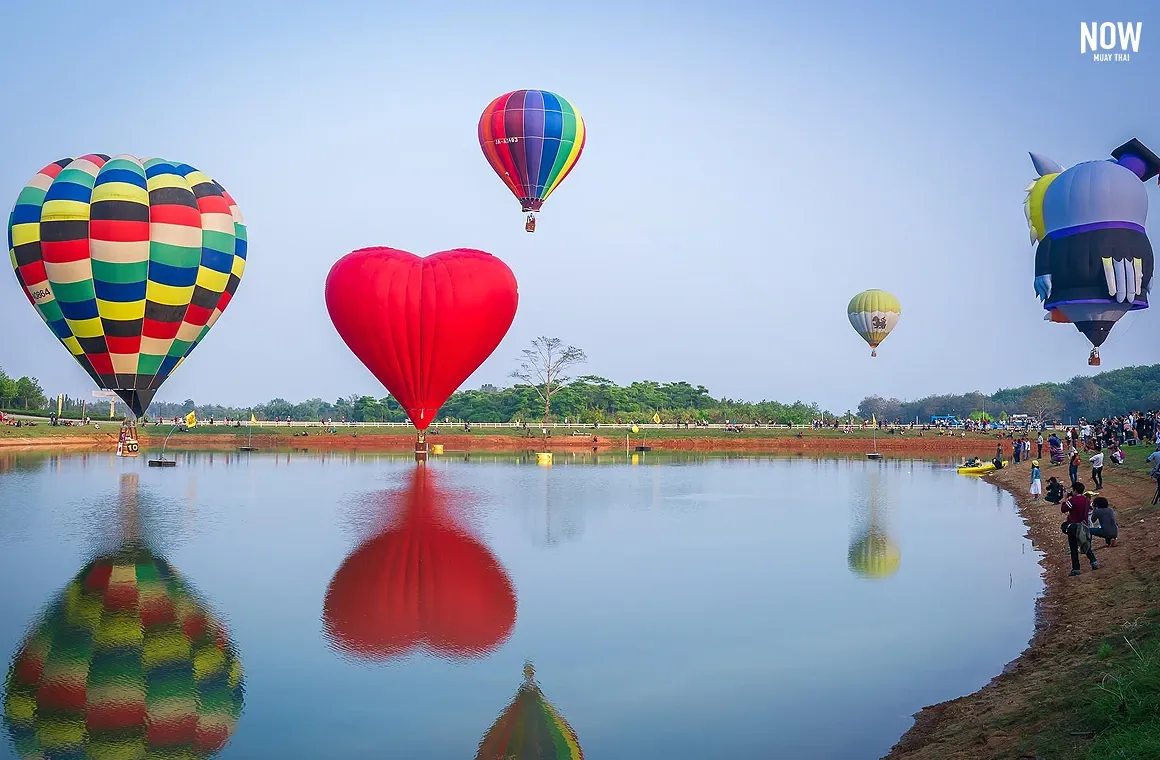 5 Parachutes over a lake at Singha Park, Chiang Rai, Thailand, adventure activities, outdoor recreation, scenic landscape, tourist attraction, water sports, travel photography.