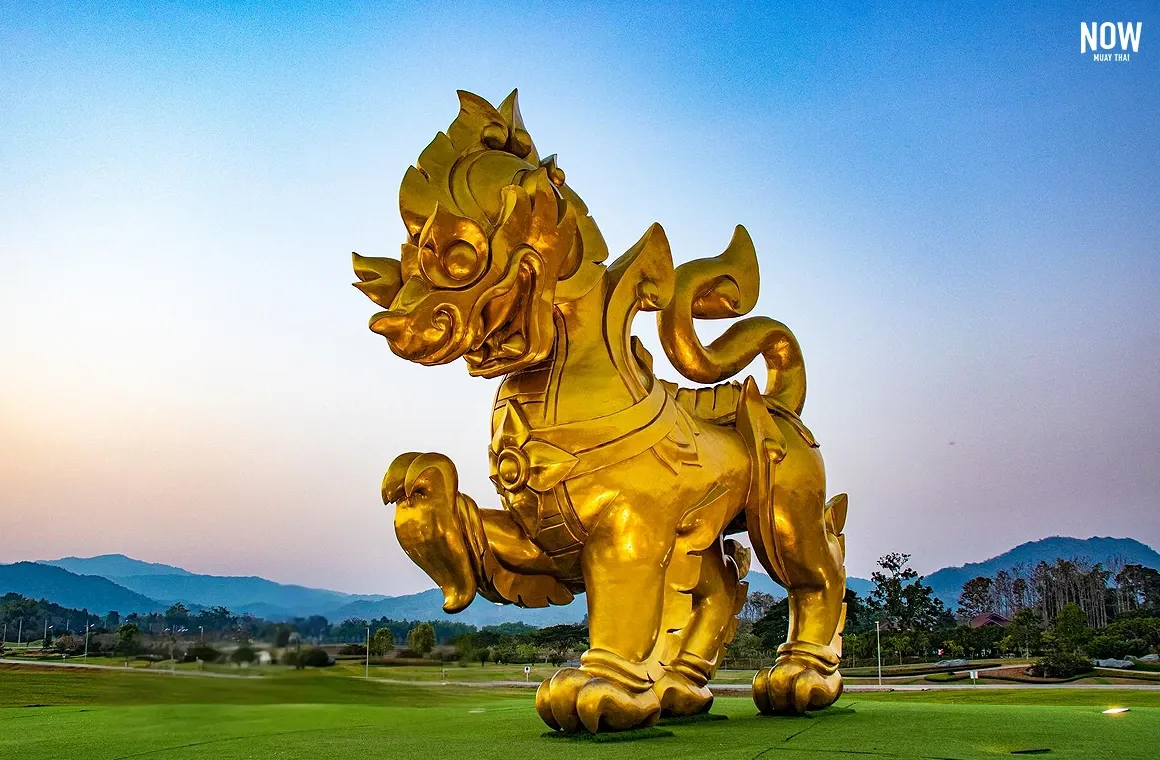 Golden Singha lion statue at Singha Park, Chiang Rai, Thailand, clear blue sky, iconic landmark, tourist attraction, travel photography.