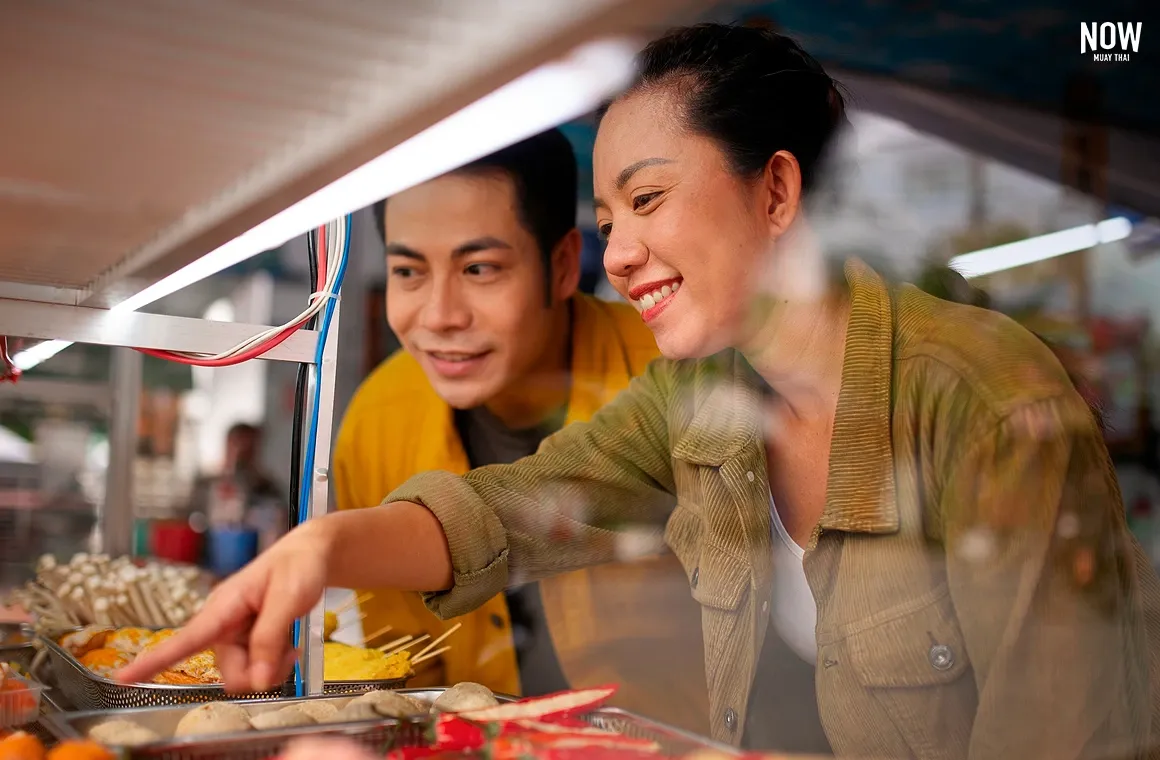 Chiang Rai Night Bazaar, vibrant market stalls, street food vendors, local crafts, bustling atmosphere, traditional Thai snacks, souvenir shopping, evening market, tourist attraction.