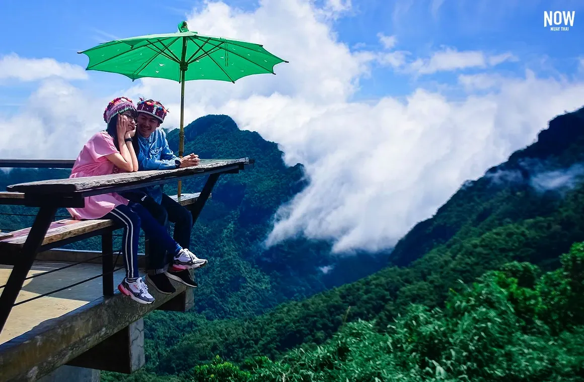 Couple on bench, Phu Chi Fa viewpoint, Chiang Rai, Thailand, mountains, clouds, scenic landscape, travel, romantic view.