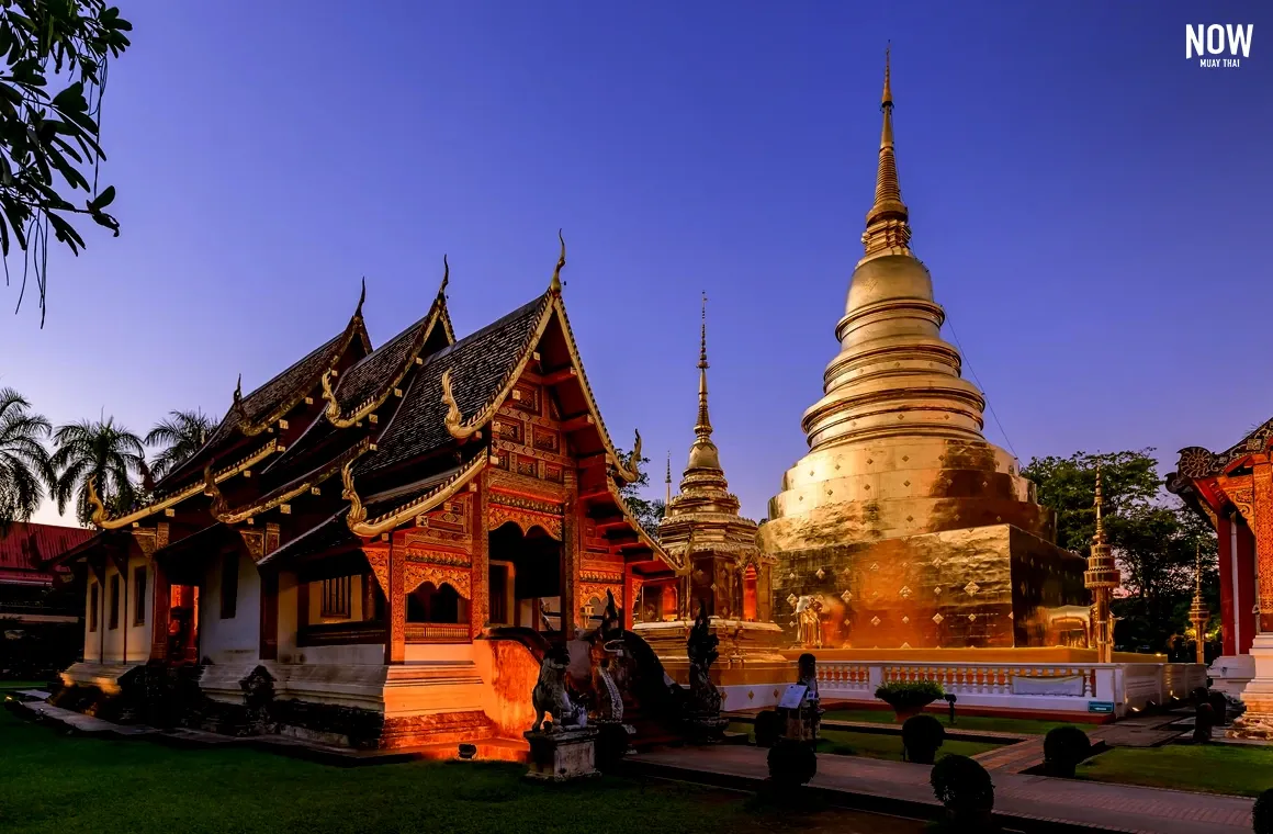Chapel and golden pagoda at Wat Phra Singh Woramahawihan in Chiang Mai at twilight with starry sky — blending culture, religion, and deep spiritual devotion.