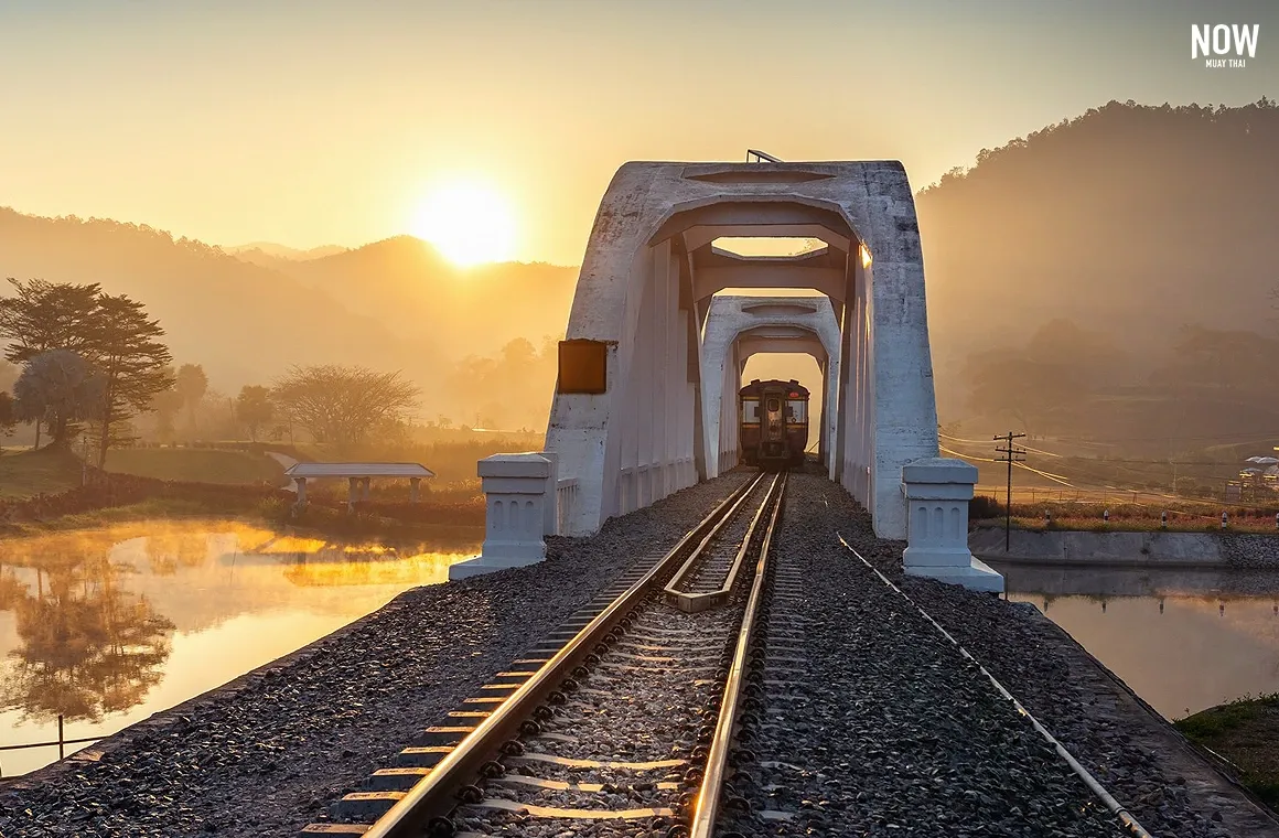 Morning sunlight over Tha Chomphu White Bridge in Lamphun, Thailand — a landmark on the train journey to Chiang Mai, signaling you are just over an hour from arrival.