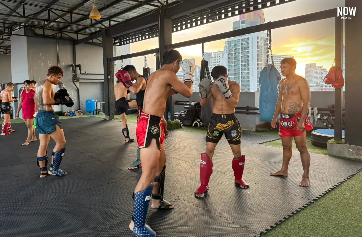 Muay Thai fighters training at the gym, following the Kru's instructions