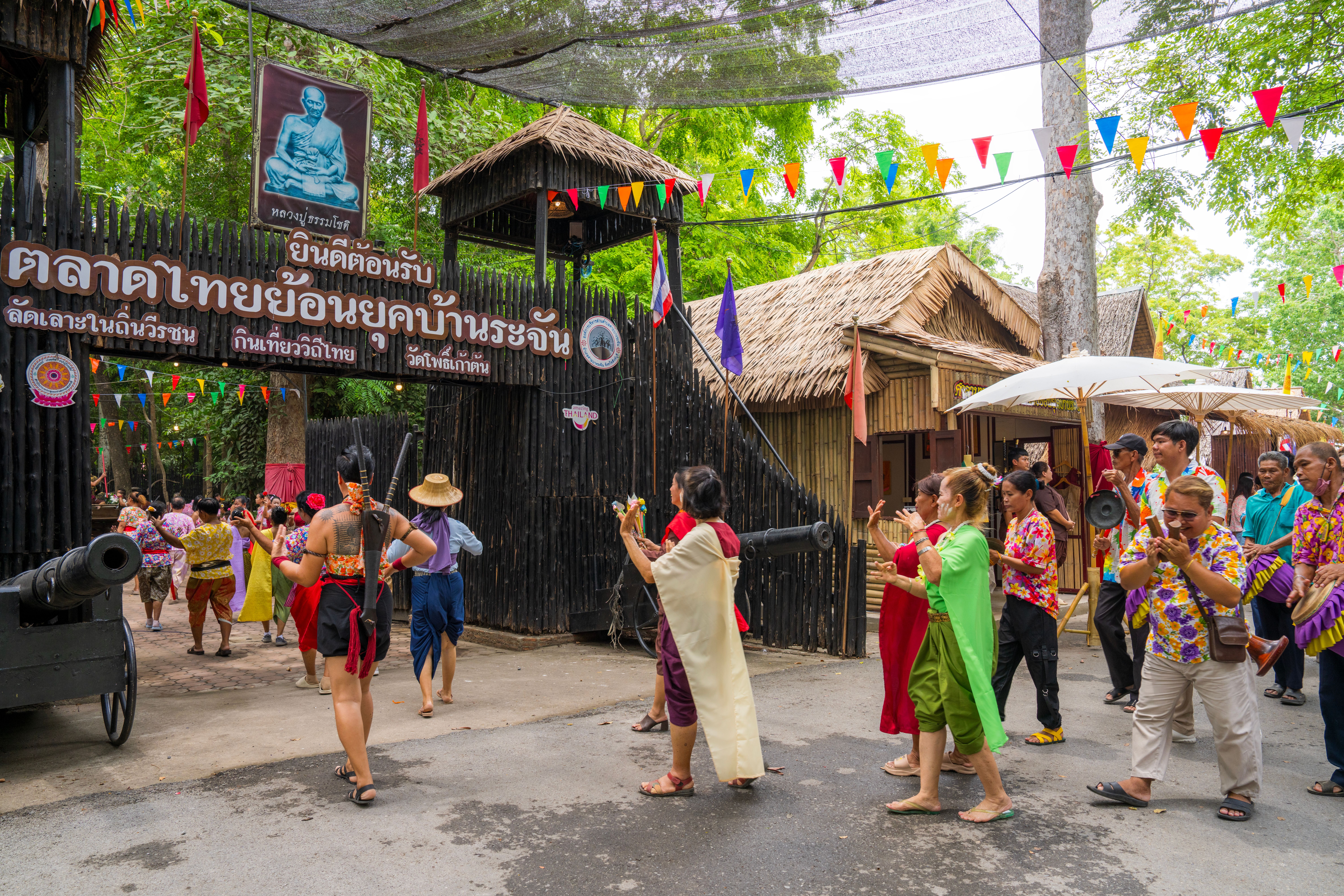 A procession of people in traditional Thai costume at Banrachan Retro Market, Sing Buri