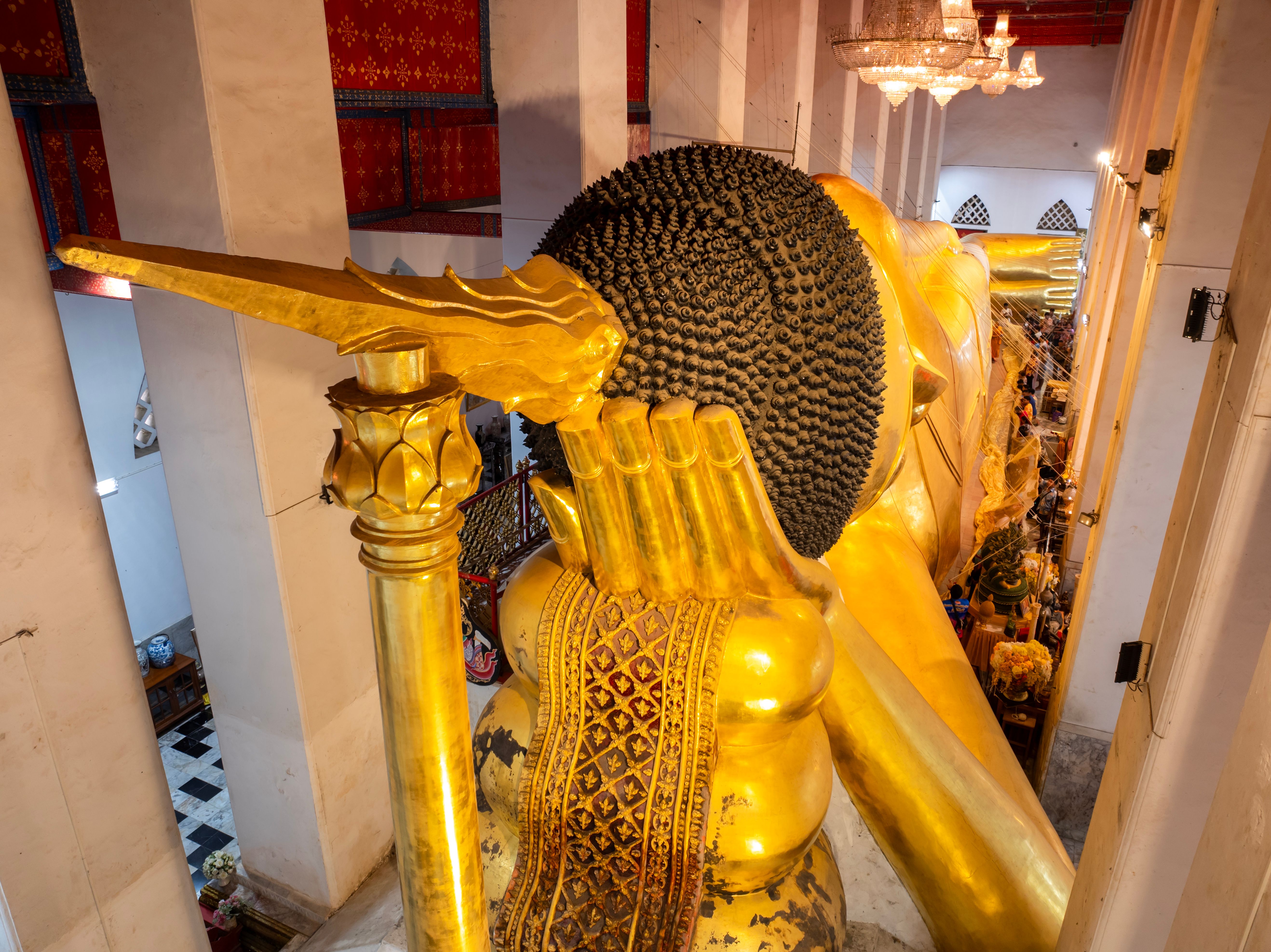 The reclining Phra Non Chaksi Buddha stretching the length of the hall at Wat Phra Non Chaksi Worawihan, Sing Buri