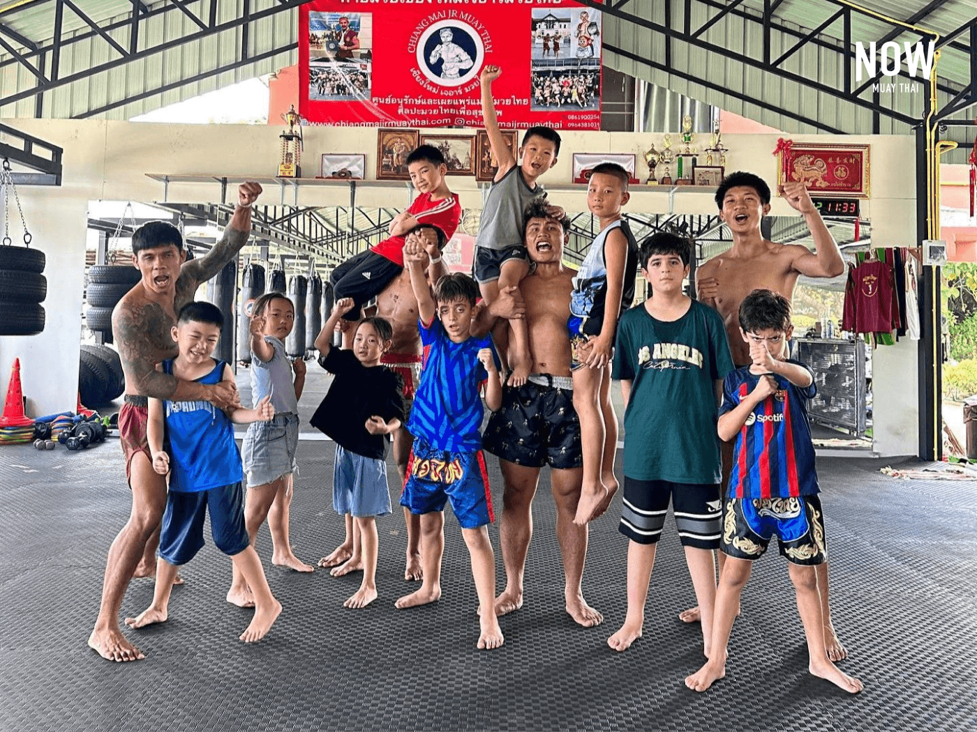 Adults and children pose at Chiangmai JR Muaythai Gym