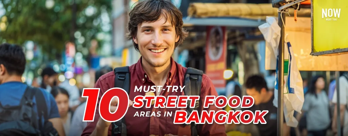 Street-Food-Bangkok-cover, man standing at the street food marking, looking at the camera and smiling, while holding some streetfood in his hands