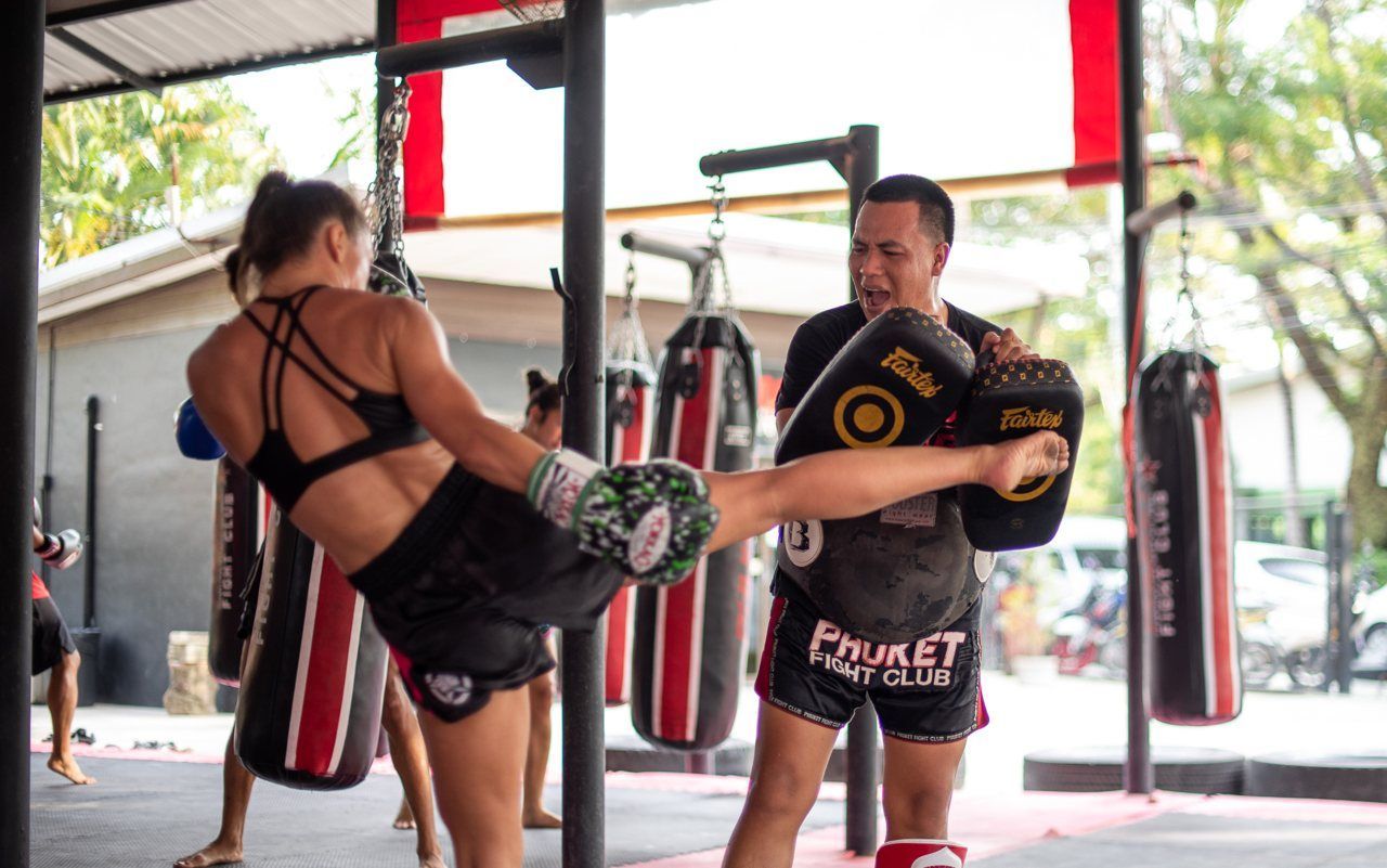 Two members of the Phuket Fight Club Muay Thai gym train with pads in Phuket, Thailand
https://www.nowmuaythai.com/class/5-CLASS-MUAY-THAI-1-WEEK
