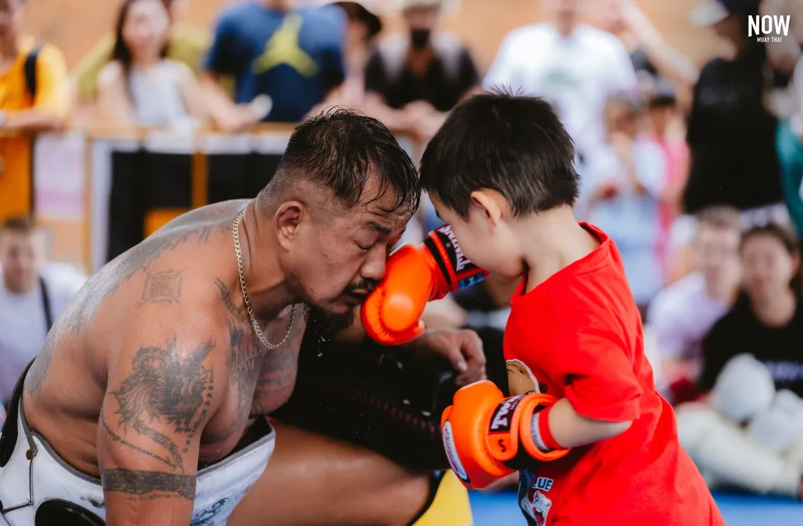 Trainer Gae training with a small boy, who punched him in the face