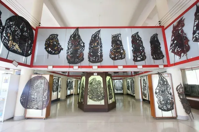Intricately carved nang yai shadow puppets on display at the Nang Yai Museum, Wat Sawang Arom, Sing Buri