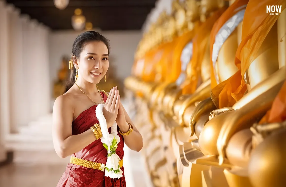 Beautiful woman in traditional Thai costume posing at an ancient Ayutthaya temple, showcasing the unique fusion of train and travel in Thailand—a blend of fitness and cultural exploration.