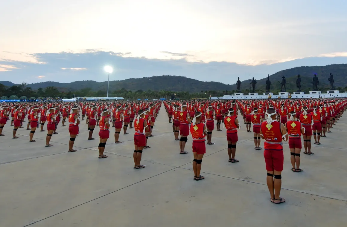 Vibrant atmosphere of the Amazing Muay Thai World Festival 2023, showcasing the traditional Muay Thai techniques in front of the revered Kings Monument at Rajabhakti Park.