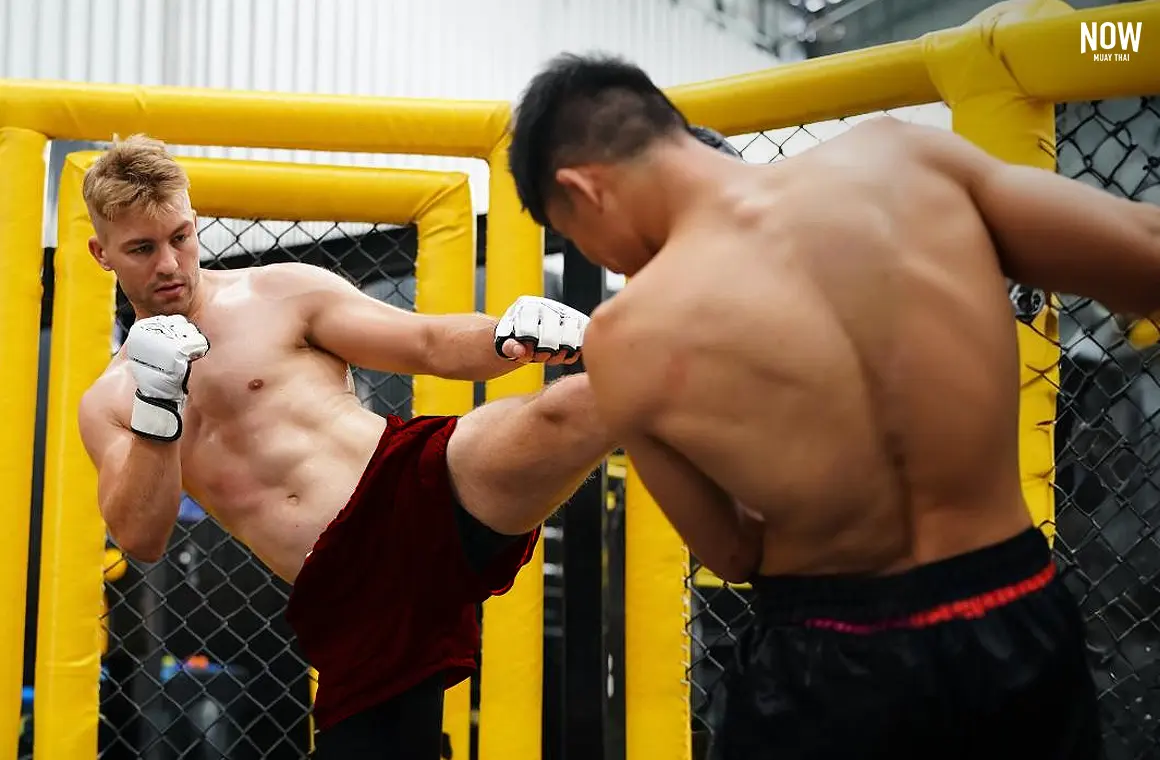  A Muay Thai fighter executing a powerful neck kick, showcasing the precision and technique of this striking martial art during a training session.