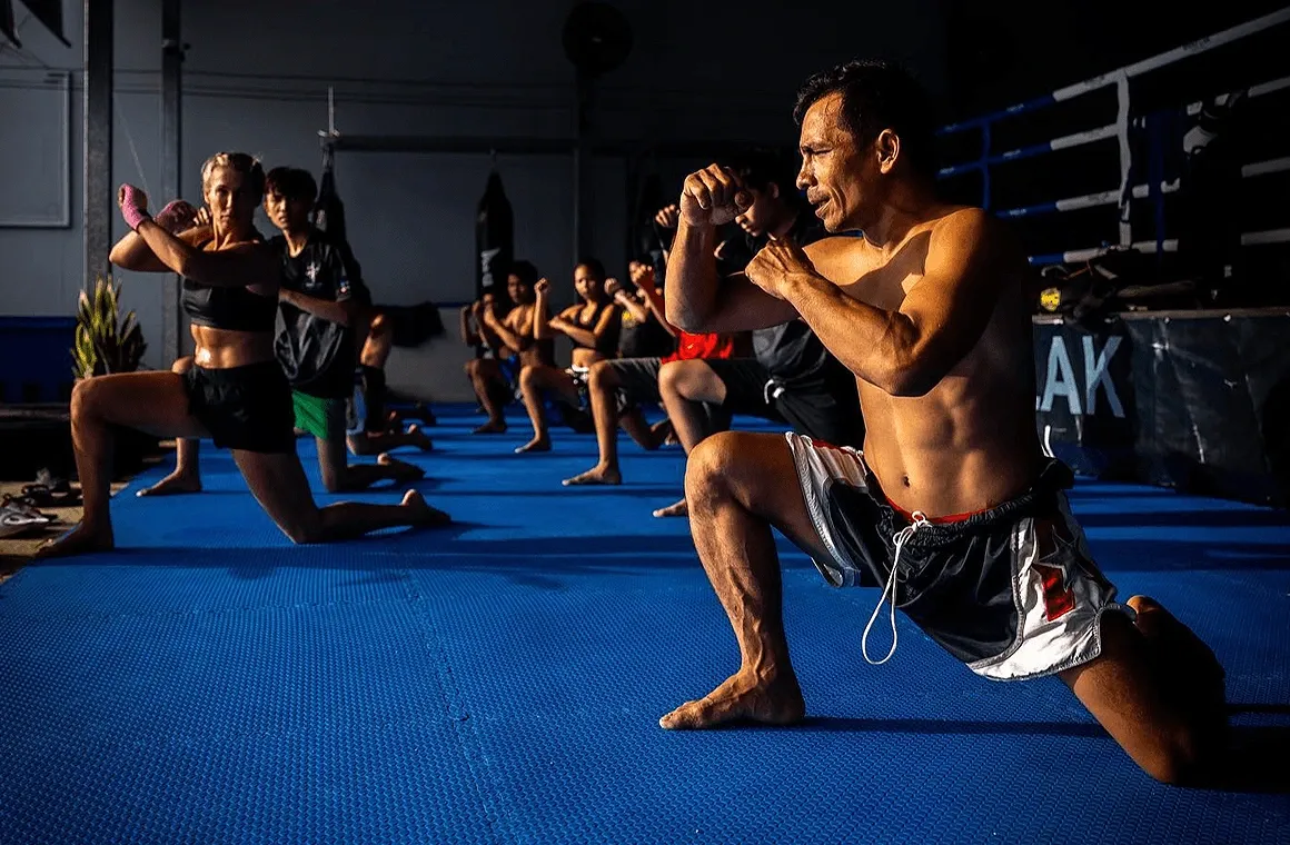 A Muay Thai class at Khao Lak Muay Thai & Muay Boran, featuring students of all levels training together in a picturesque setting, embodying a welcoming and family-like atmosphere in Khao Lak, Phang Nga, Thailand.