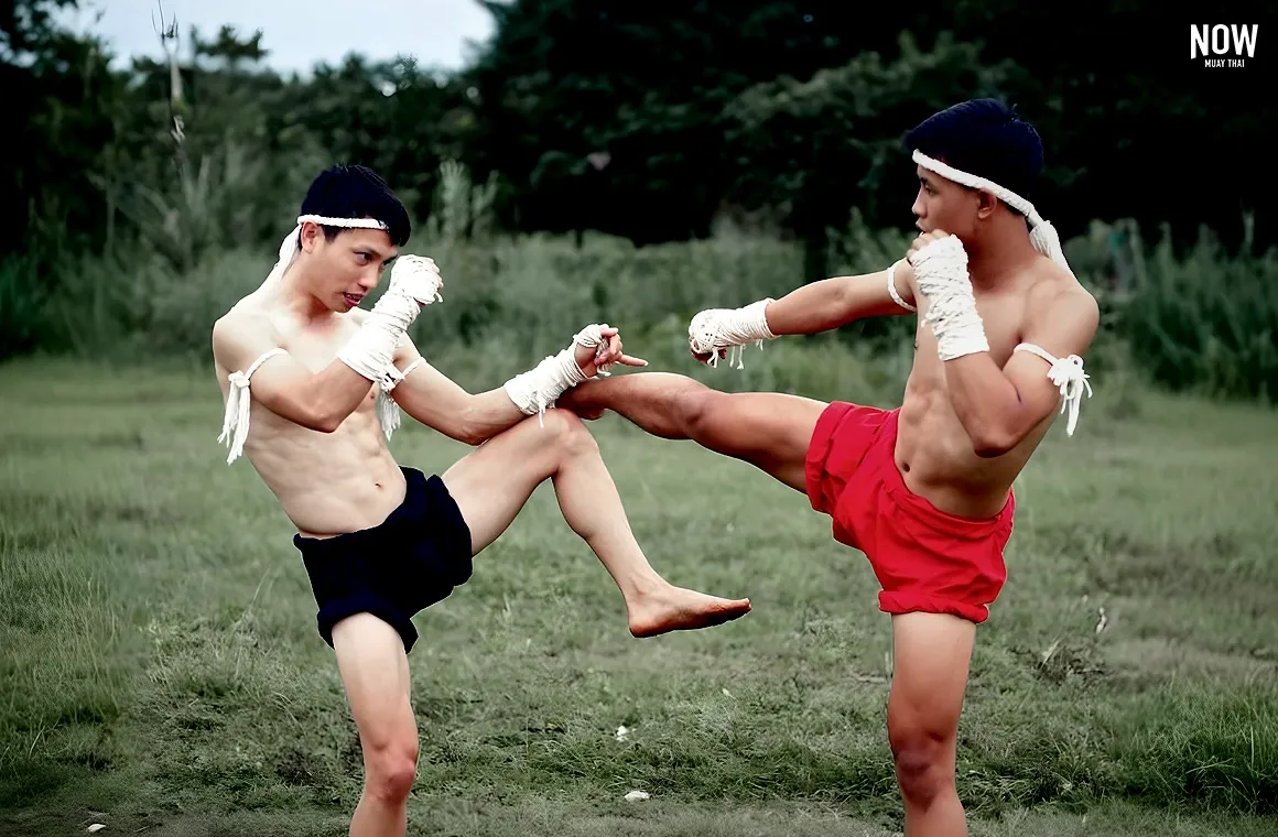 Two Muay Thai fighters demonstrate their skills in a festival setting, engaging in a friendly match to showcase technique and identify areas for improvement, celebrating the tradition of community and the spirit of Muay Thai in local festivals.