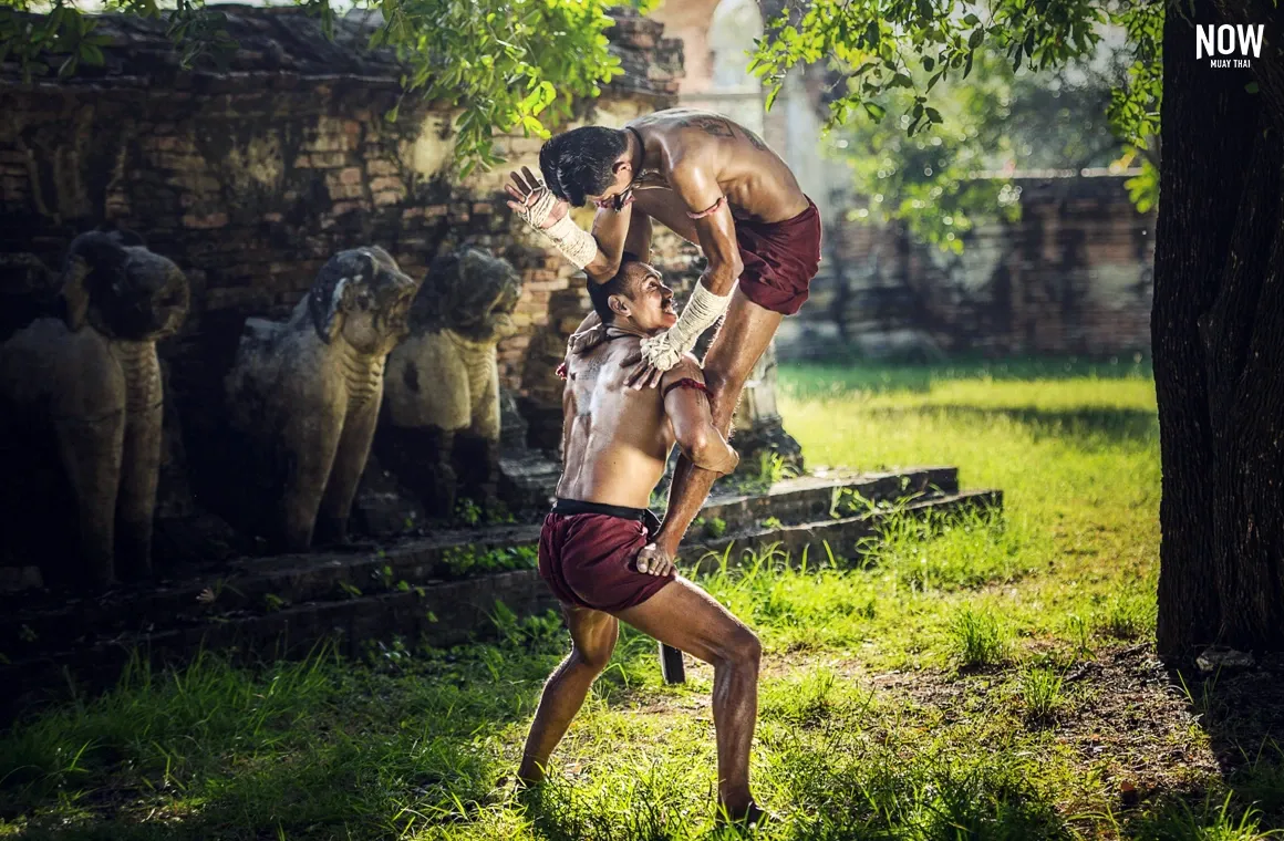 Muay Thai technique showcasing the blend of 'Mae Mai' and 'Luk Mai' moves. The image illustrates the 'Rue See Bod Ya' technique, where the fighter delivers a downward elbow strike aimed at the opponent's head