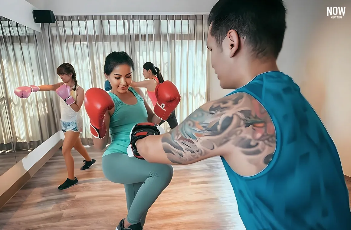 A group of excited women enjoying their Muay Thai beginner's class, fully engaged in training and having fun as they learn the basics of this dynamic martial art.