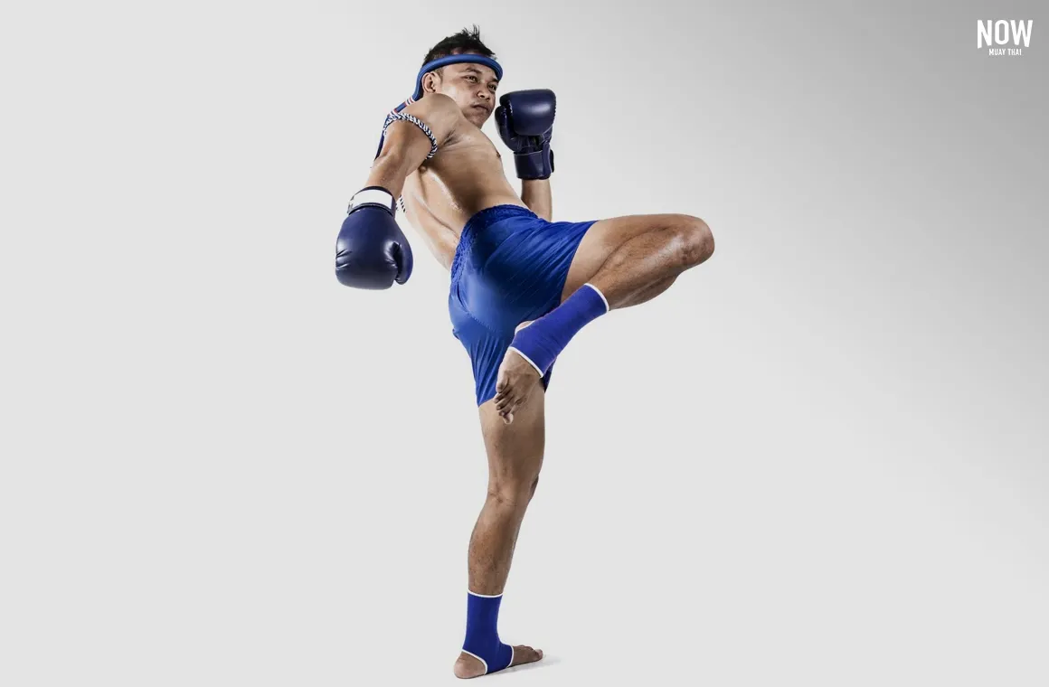 Demonstrating a basic knee strike in Muay Thai, using the knee joint to drive upward into the target. The fighter flexes the foot down to align the shin, maximizing speed and agility. 