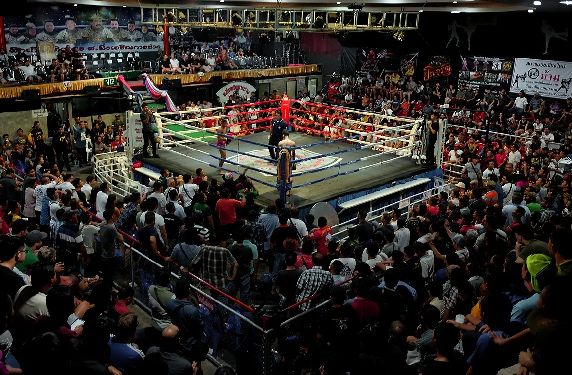 Photo of two Muay Thai fighters in action inside Chiang Mai Boxing Stadium