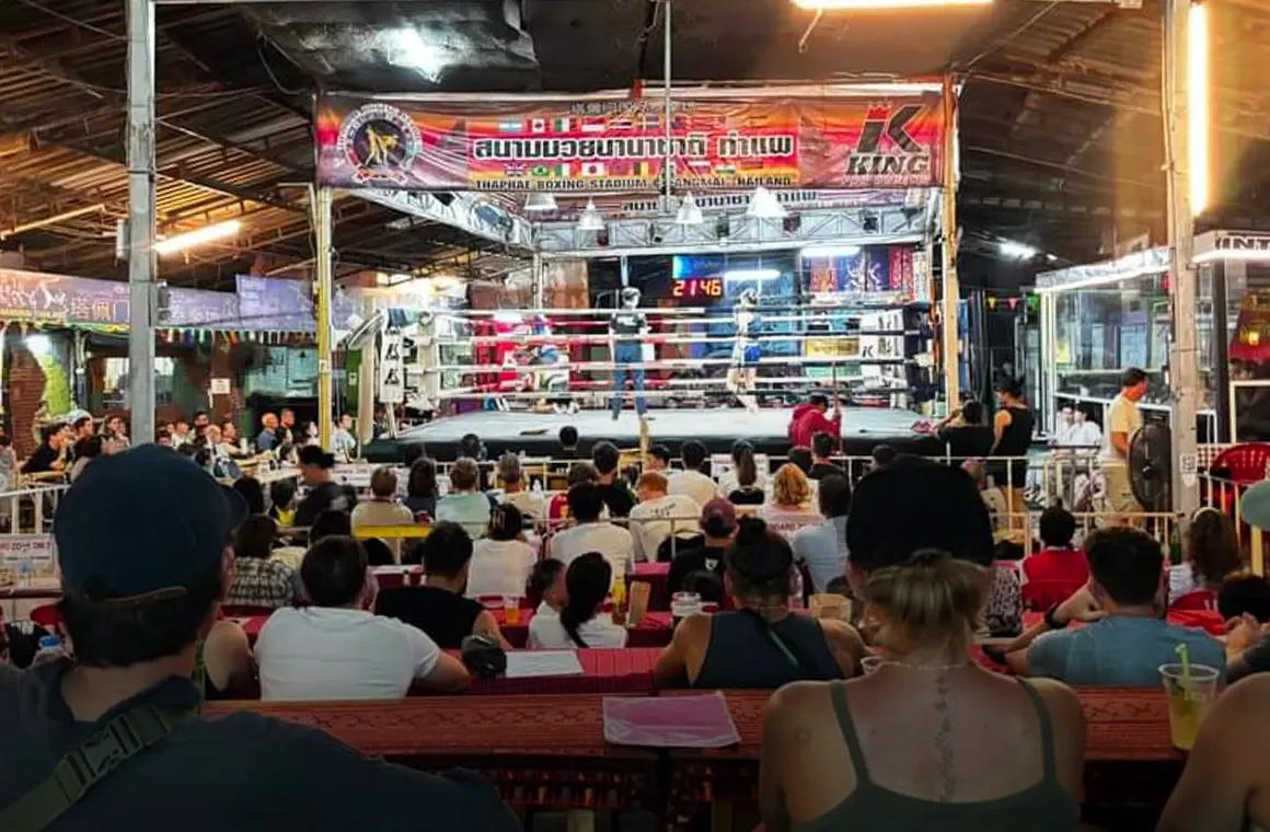 Photo of Crowded tourist watching muay thai fight in Thaphae Boxing Stadium