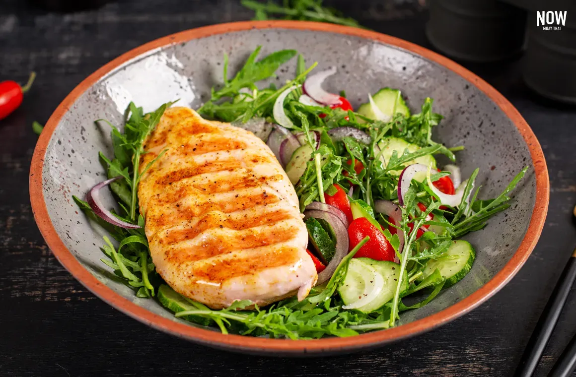 Grilled chicken breast served with a fresh vegetable salad, combining lean protein with fiber-rich greens for a nutritious and low-fat post-workout meal.