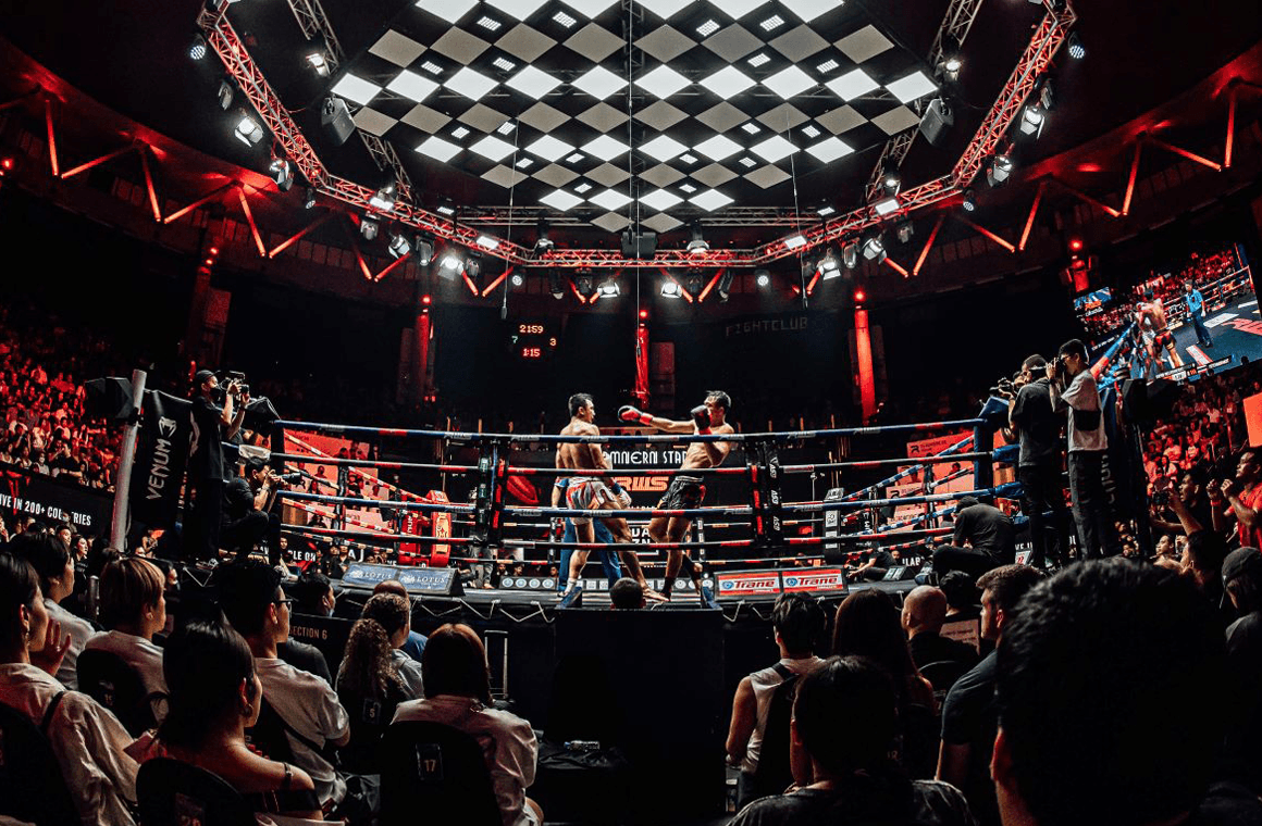 Rajadamnern Boxing Stadium inside, audience, boxing match and red lighting