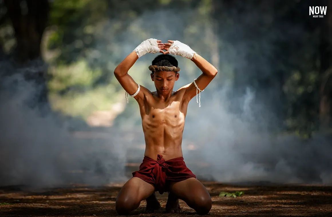 A young man performing Wai Kru, symbolizing Muay Thai’s spiritual depth where strength meets mindfulness. 