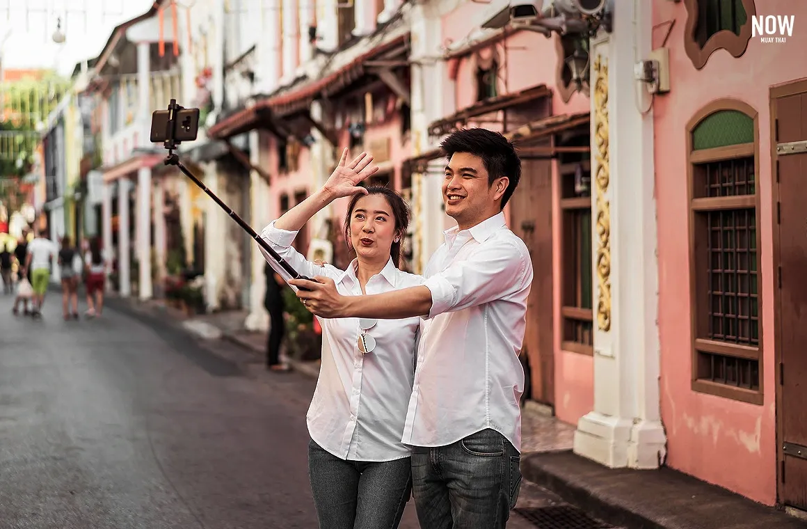 Happy young Asian couple in love having a good time in Old Phuket Town, Phuket, Thailand