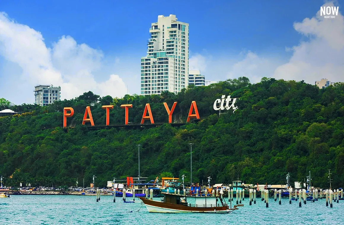 A scenic view of the Pattaya City sign overlooking Pattaya Bay, showcasing why Pattaya is a vibrant, never-sleep city with two long beaches - Pattaya Beach and Jomtien Beach - offering endless activities.