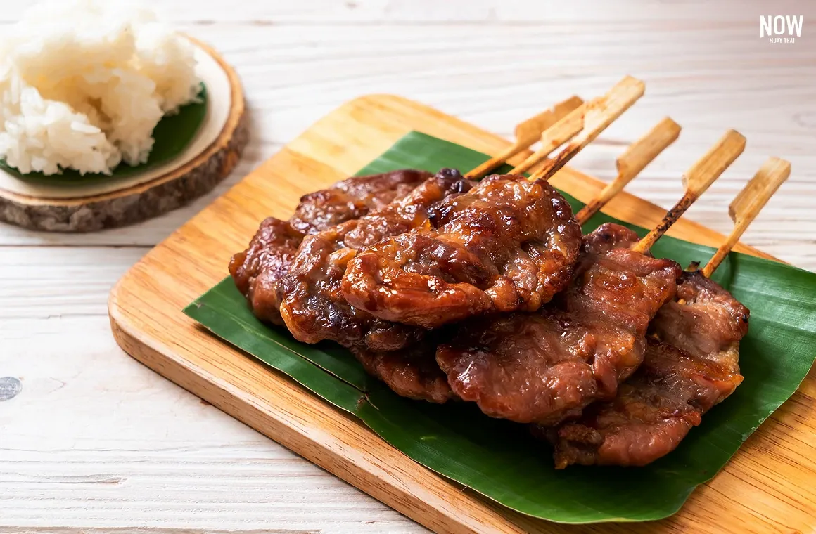 Sticky rice with grilled pork (Khao Niew Moo Ping) is a popular breakfast dish among Thai people of all ages, offering a delicious and satisfying combination of savory grilled pork and sticky rice, making it a favorite for starting the day.