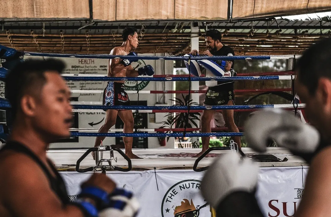 Training Muay Thai at Sumalee Boxing Gym in Phuket; offers authentic Muay Thai classes for all levels, with traditional training methods like pad work, bag work, and sparring, just 15 km from Bang Tao Beach.