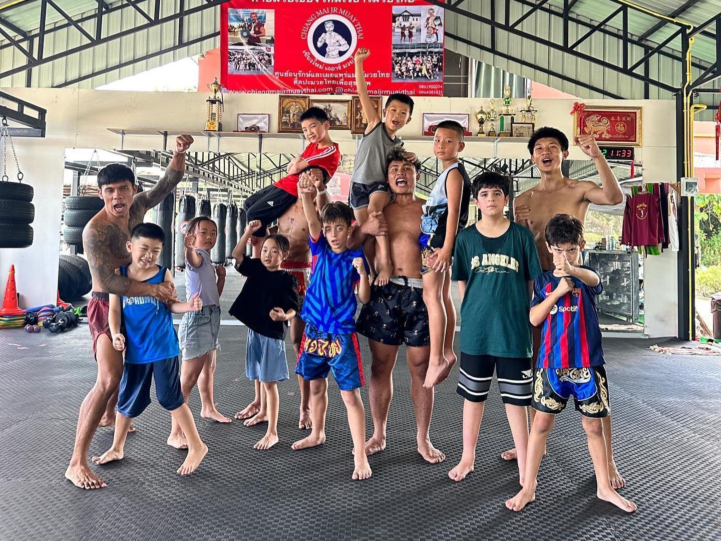 Adults and children pose at Chiangmai JR Muaythai Gym