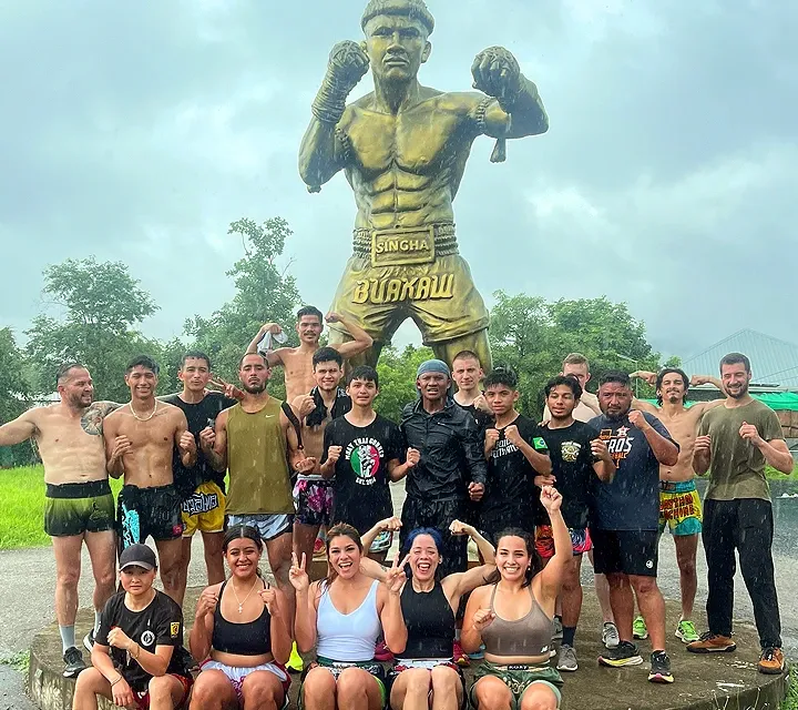 Buakaw standing proudly with his international students in front of the Gym.