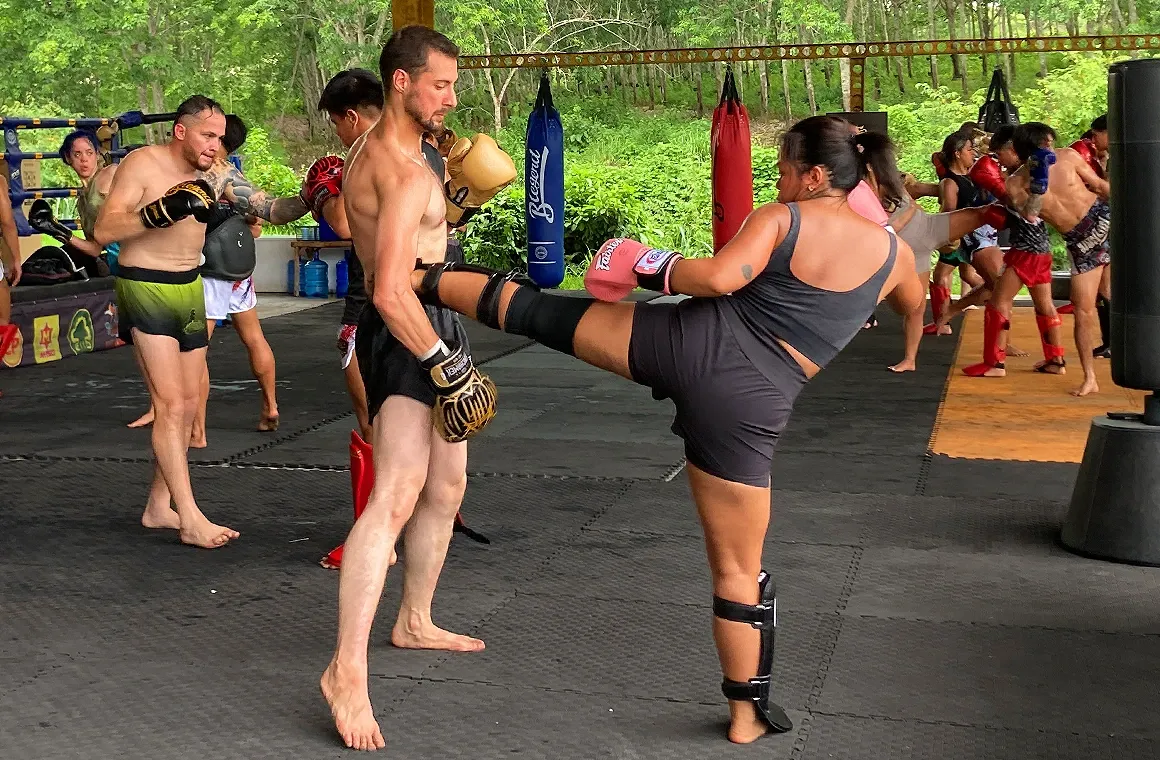 Group training at Banchamek Gym, where Muay Thai students from around the world sharpen their skills through partner drills and sparring in Chiang Mai.