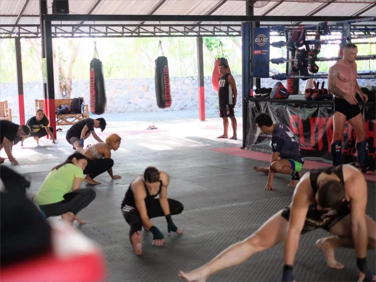 Muay Thai trainers and athletes warming up at the Elite Fight Club Hua Hin.