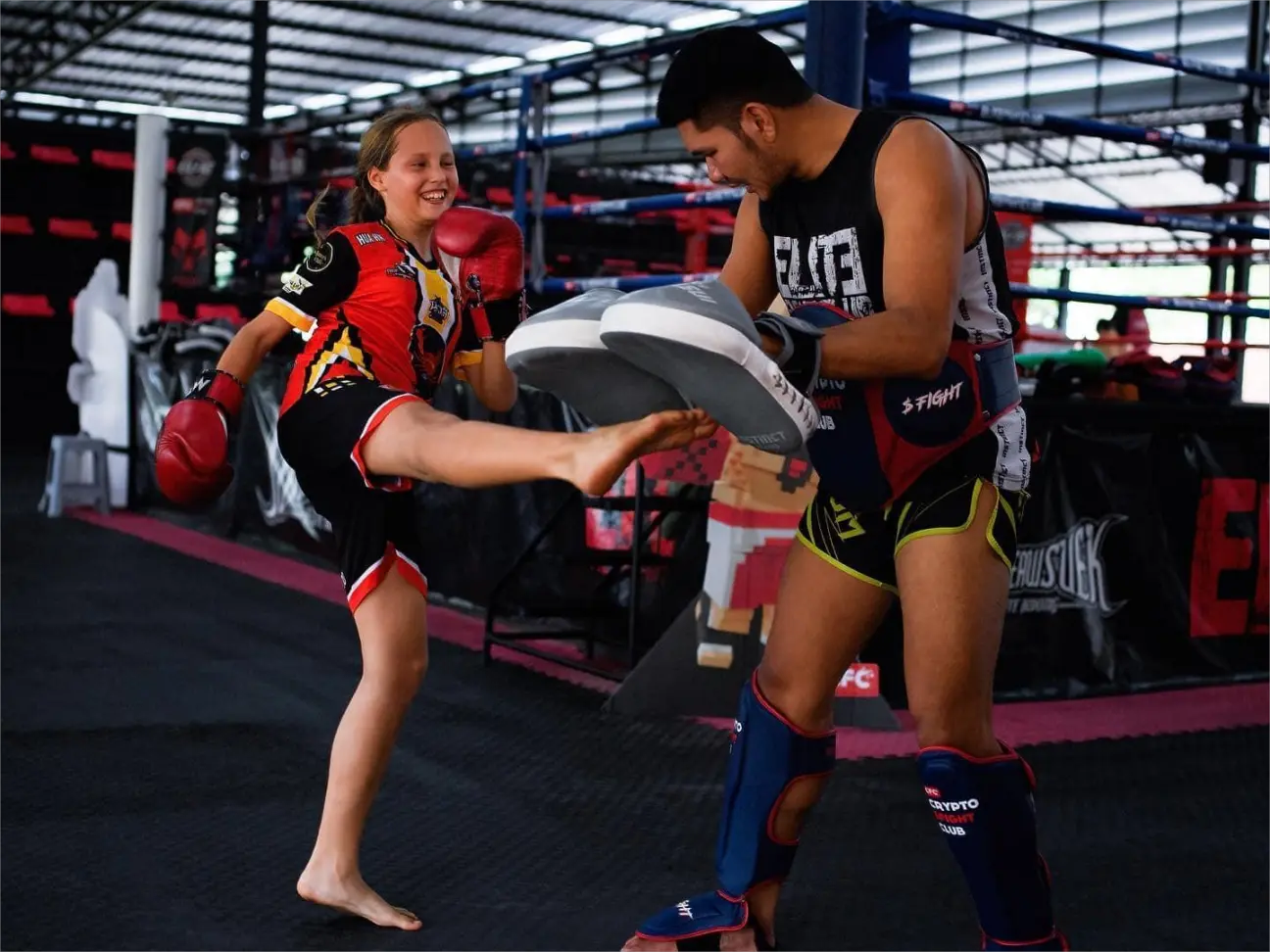 Trainer and young gym goer doing Muay Thai pad work at the Elite Fight Club in Hua Hin.