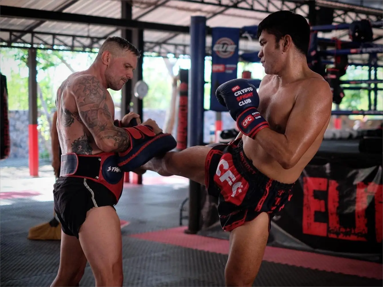 Trainer and athlete during Pad Work at Elite Fight Club Muay Thai gym in Hua Hin.