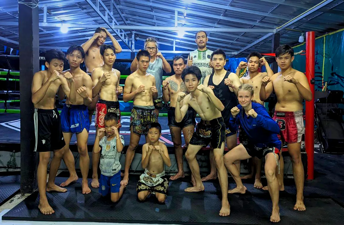 Group photo of trainers, Muay Thai boxers and Marie Rumet (Snow Leopard) one of the Estonian female Muay Thai boxers. She is from Tonkhar MuayThai Gym in Chiang Rai.