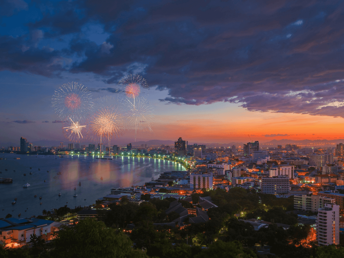 The city of Pattaya and the beach at night with fireworks.